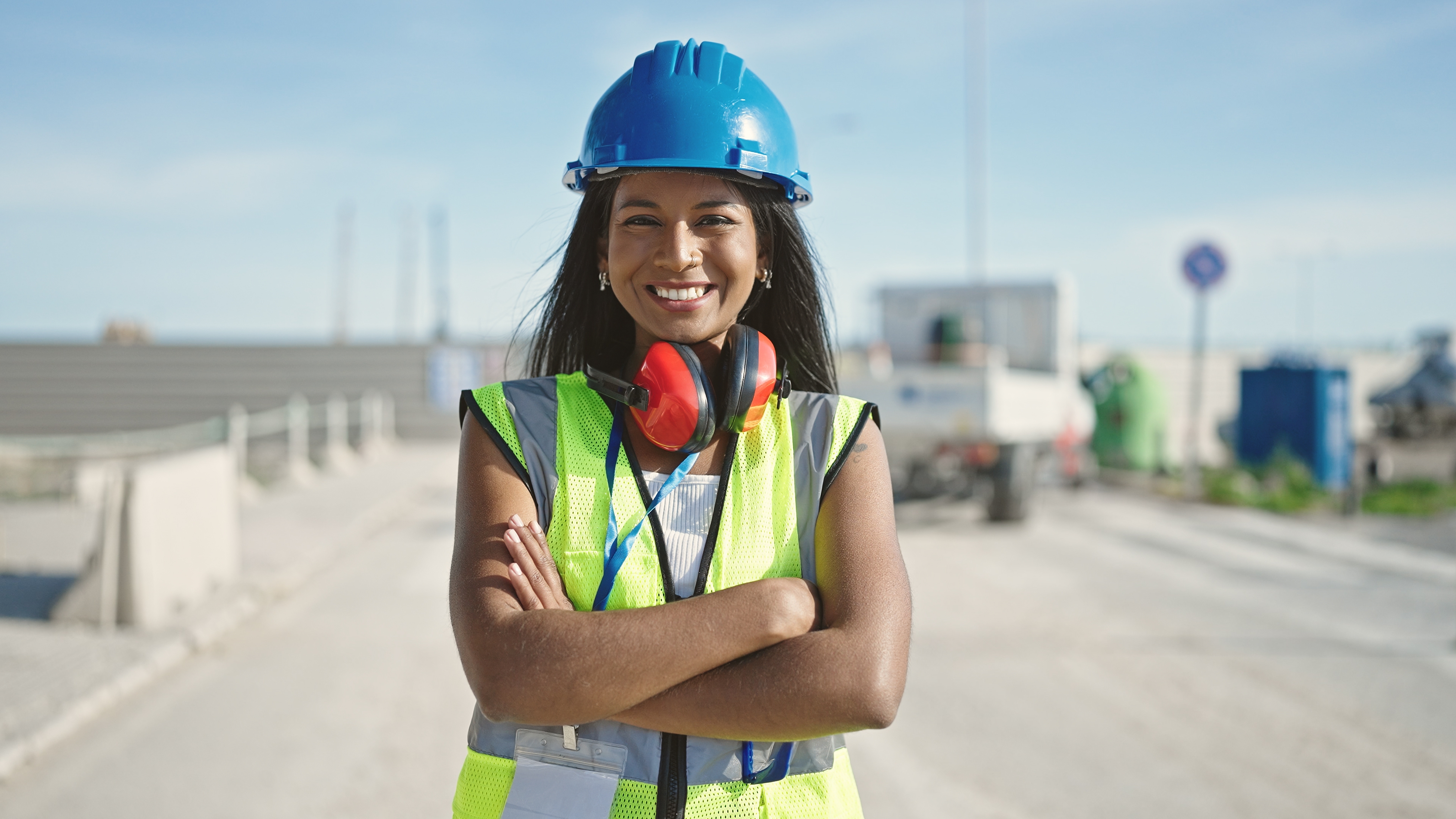 Woman in hard hat and safety vest on construction site